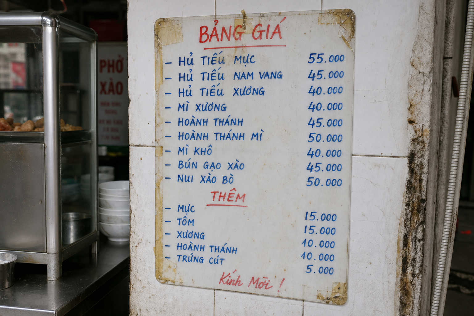 Handwritten Vietnamese street food price board listing noodle dishes and prices in dong