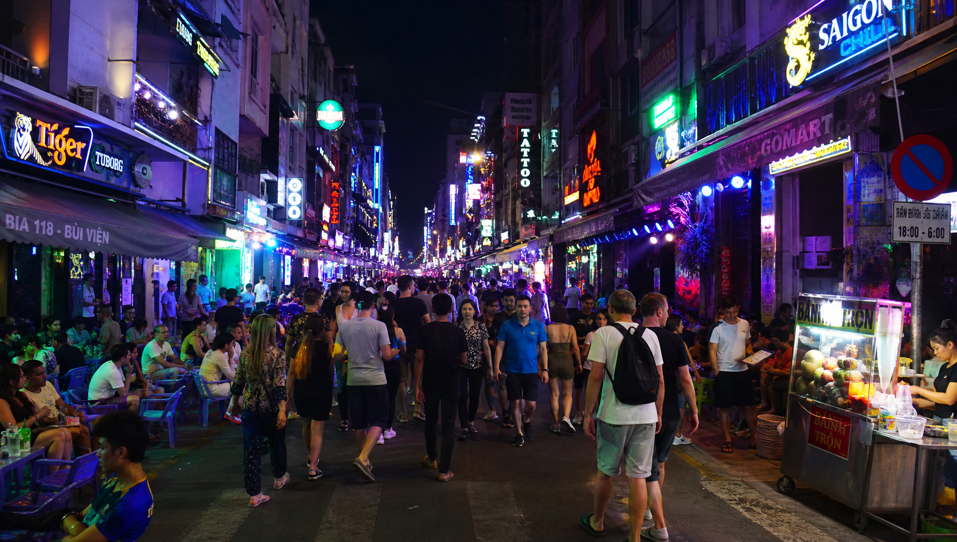 Bui Vien walking street at night in Ho Chi Minh City with neon signs and street food carts