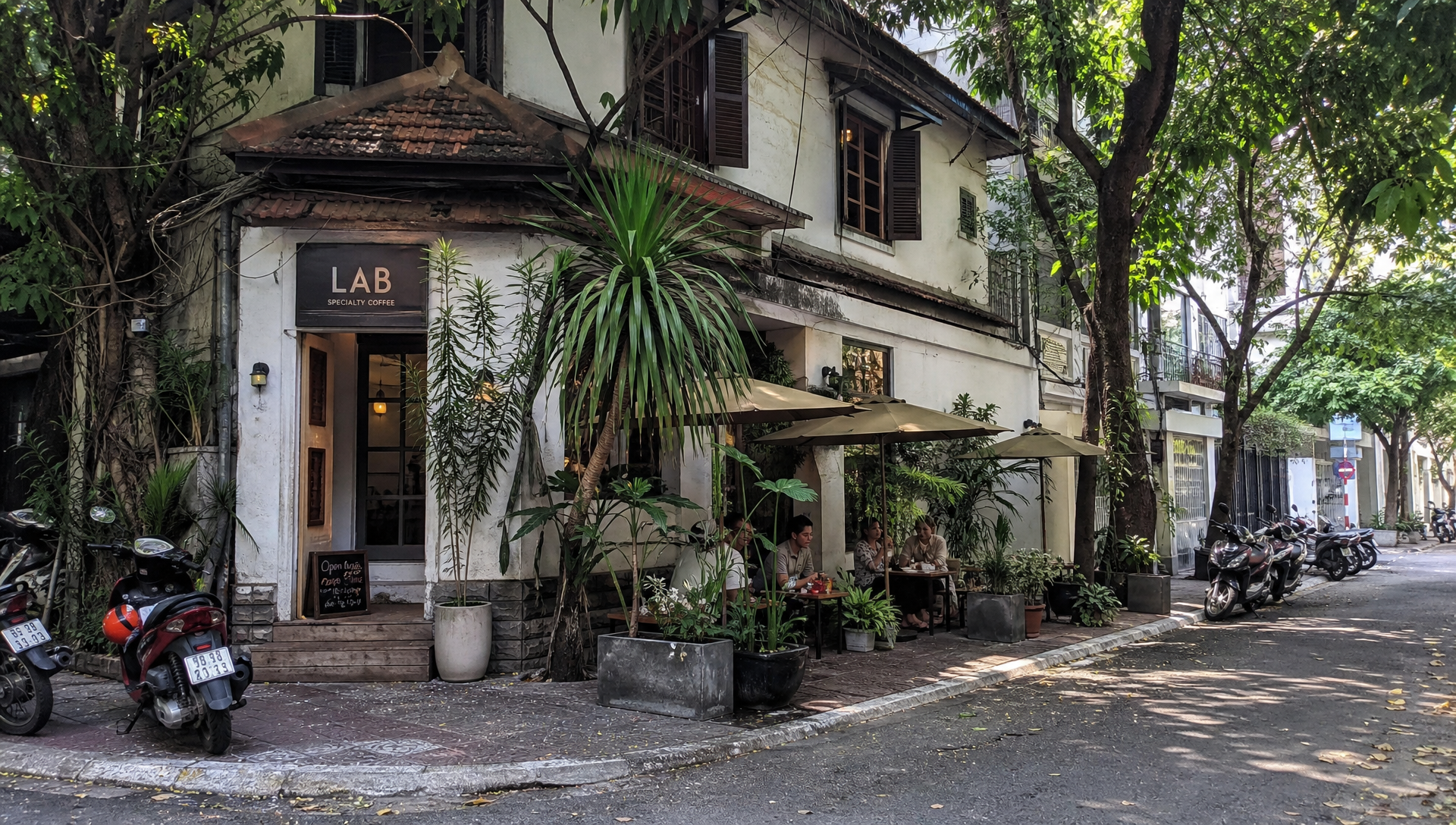 Quiet residential street in District 3, Ho Chi Minh City, with a small specialty coffee shop