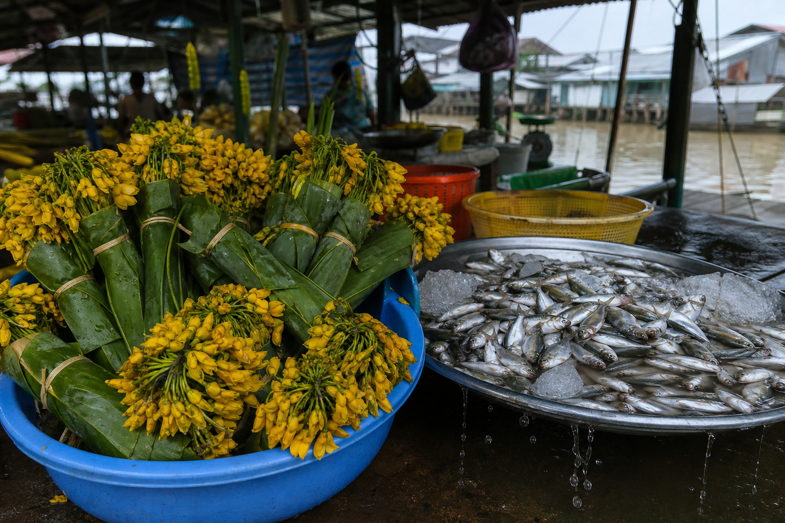 Market stall with bundles of yellow sesbania flowers and small silver river fish on a tray