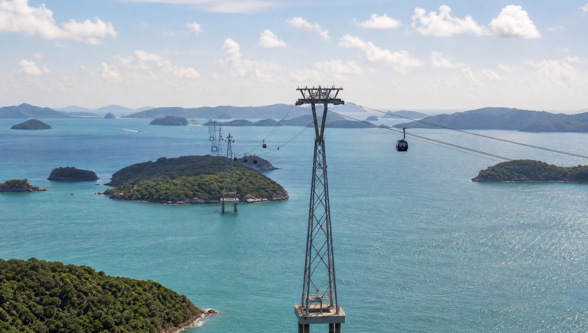 A cable car gondola crossing over open turquoise sea on tall pylons, with small forested islands visible in the water below