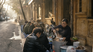 Early morning phở stall on a narrow Hanoi Old Quarter pavement during the cool dry season